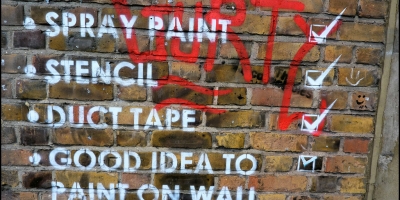 Checklist on brick wall. Spray paing, stencil, duct tape, good idea to paint on wall