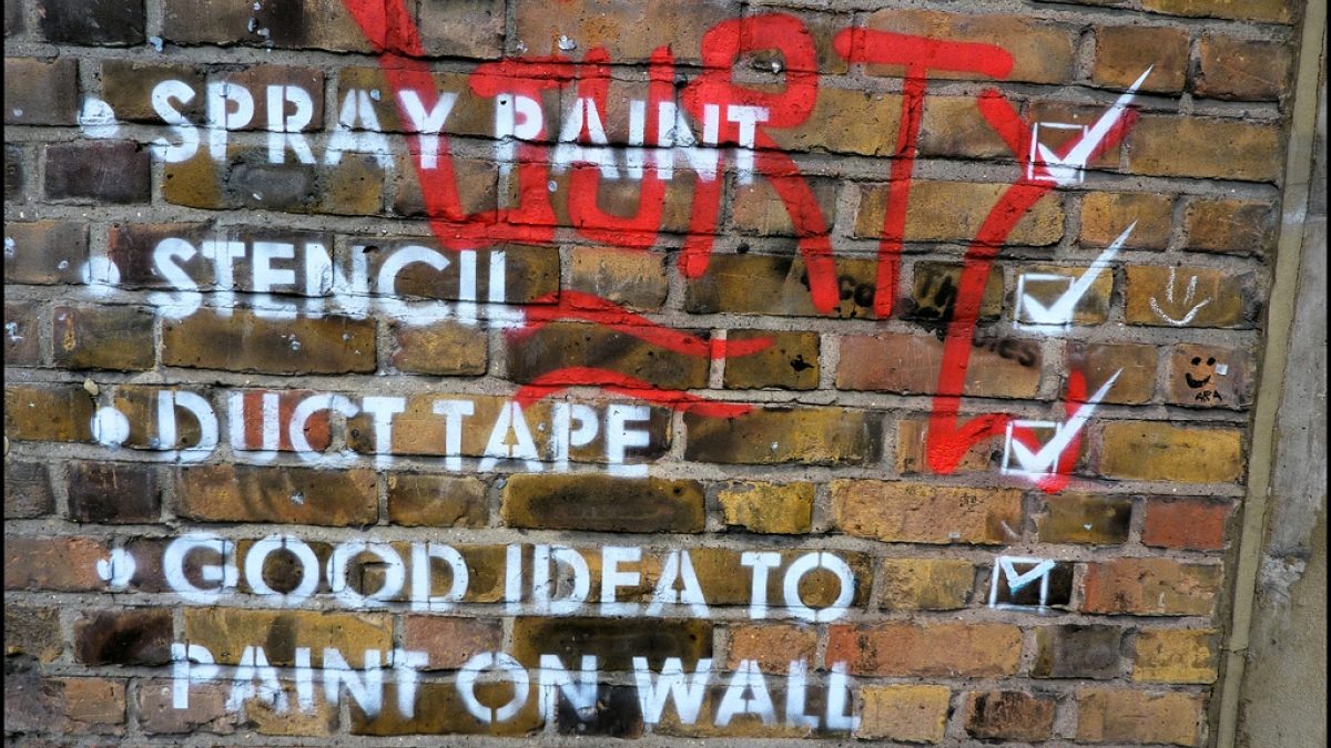 Don't Lose Your Assets In a Redesign (part 1) Checklist on brick wall. Spray paing, stencil, duct tape, good idea to paint on wall